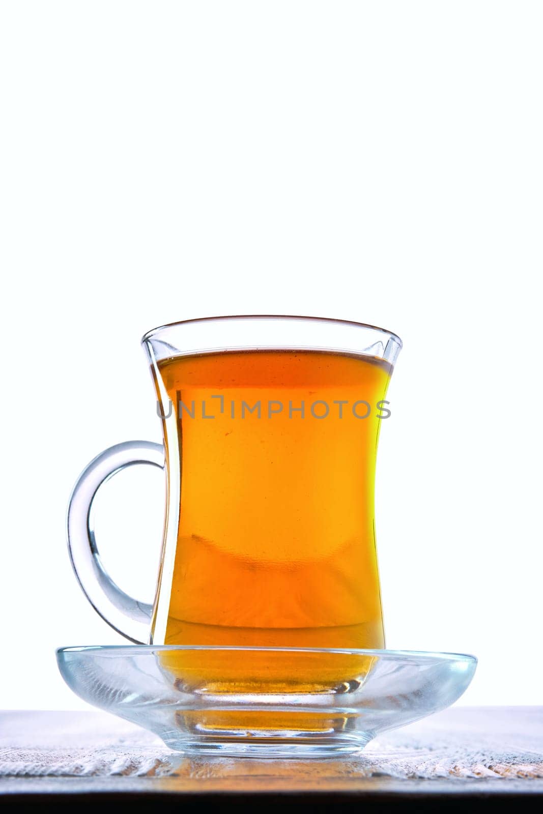 Low angle photo of cup with hot tea with copy space on white background