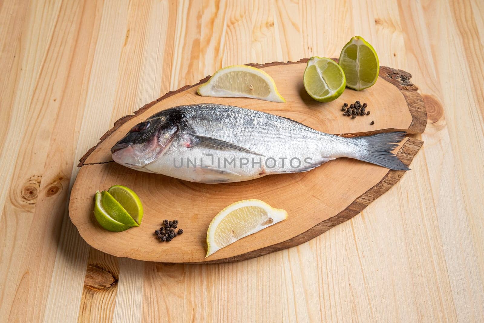 Fresh raw dorada on wooden cutting board