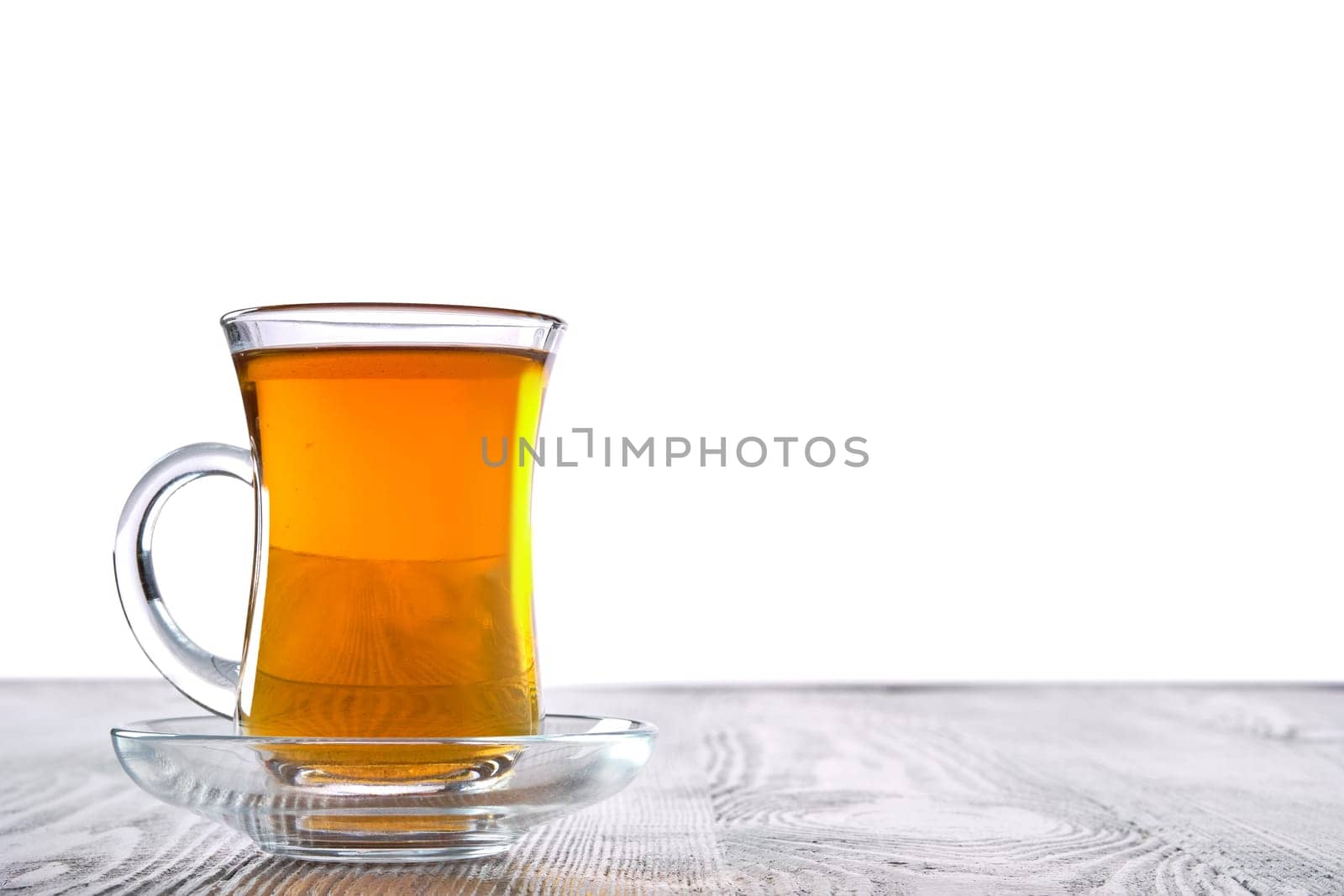 Low angle photo of cup with hot tea with copy space on white background