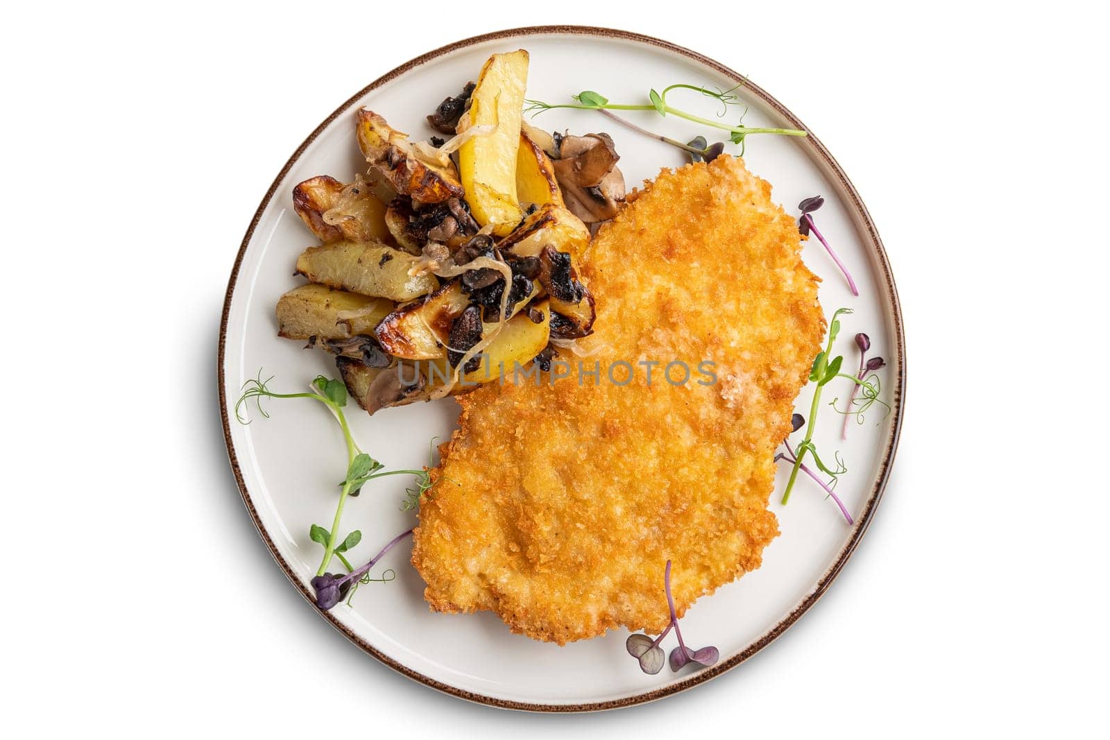 Tasty schnitzel in breading with fried potato, onion and mushrooms