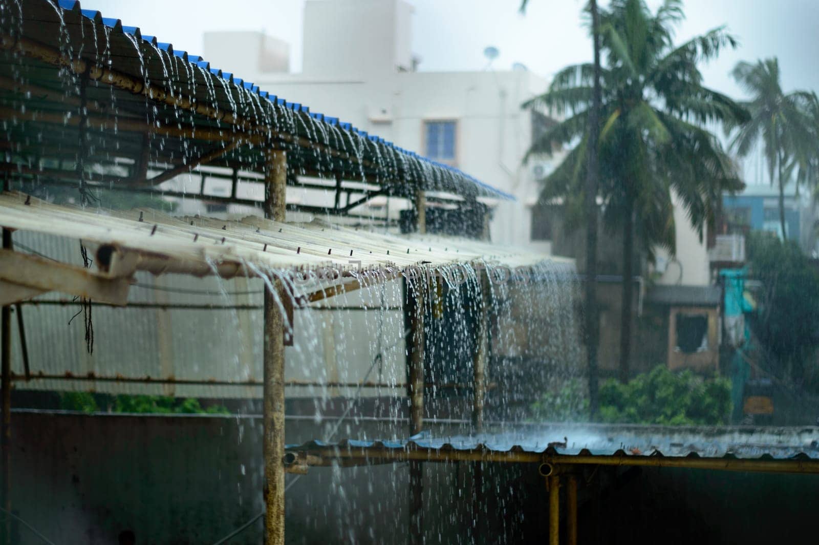 Rain on a Tin Roof. Rain Falling from the Roof. Rainy day nature background. Selective Focus on Foreground
