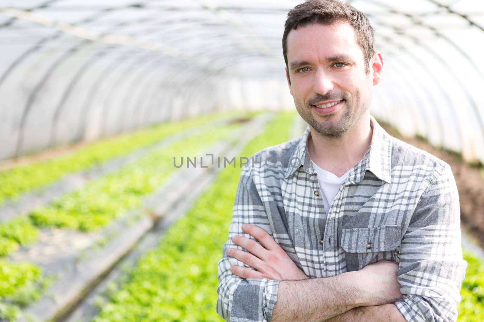 VIew of an attractive farmer in a greenhouse