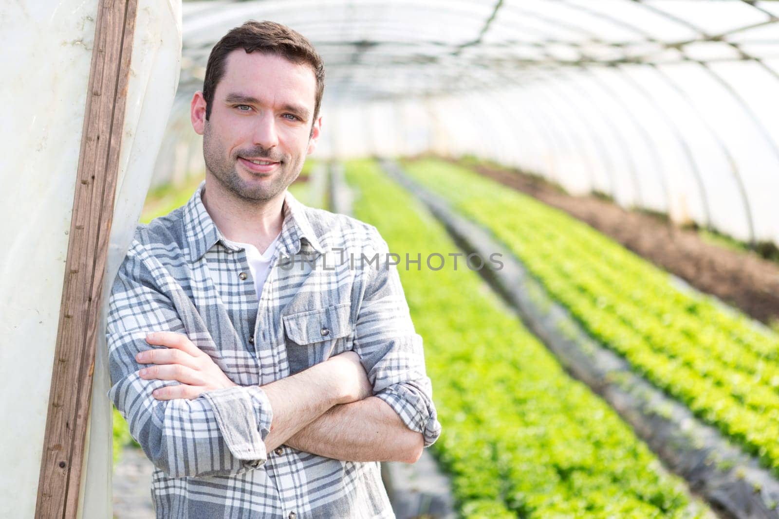 VIew of an attractive farmer in a greenhouse