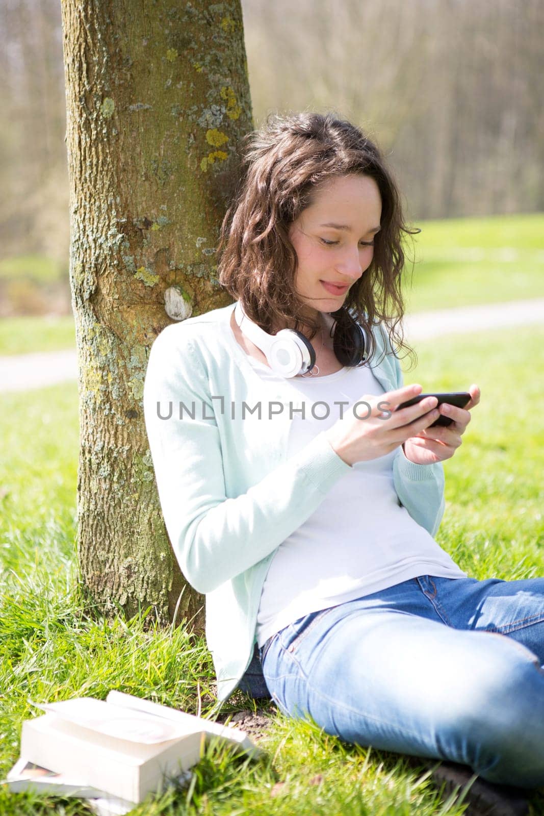 View of a Young attractive woman realxing at the park