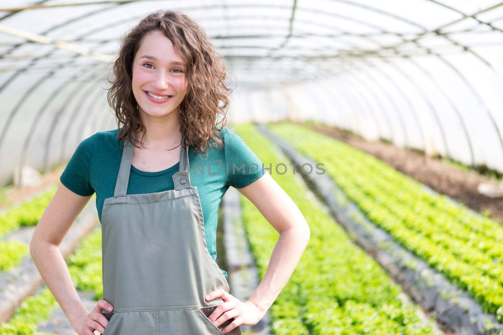 View of an attractive farmer in a greenhouse