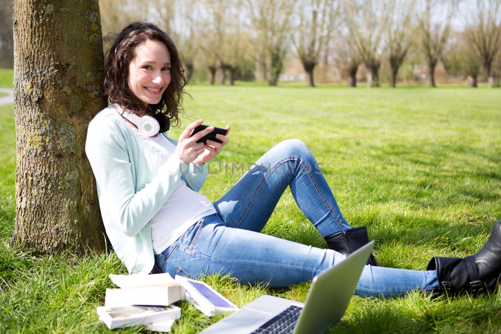 View of a Young attractive woman realxing at the park
