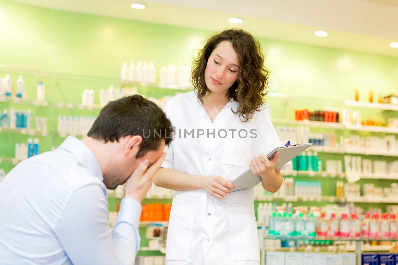 View of an Attractive pharmacist comfort a customer suffering