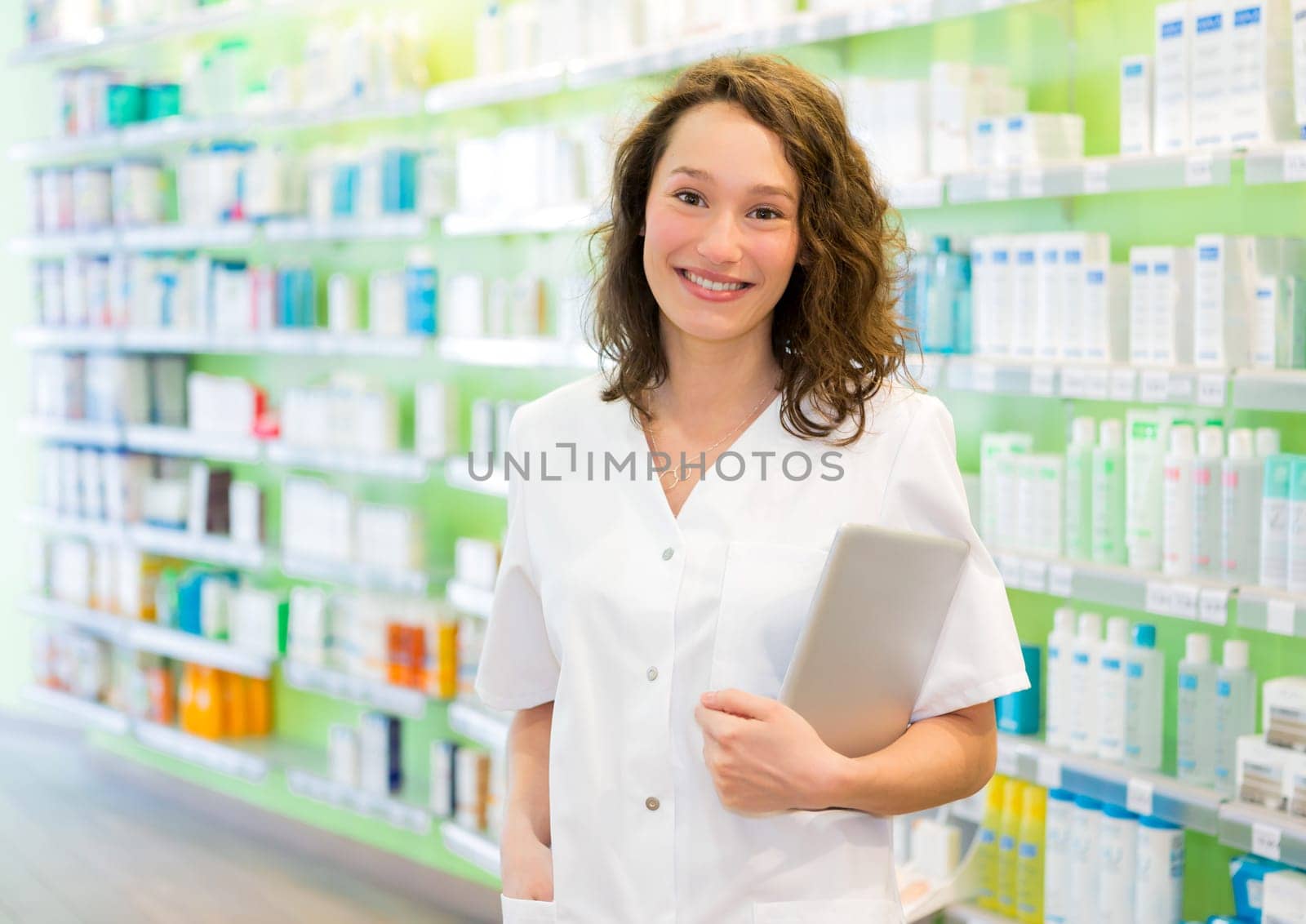 VIew of an Attractive pharmacist using tablet at work