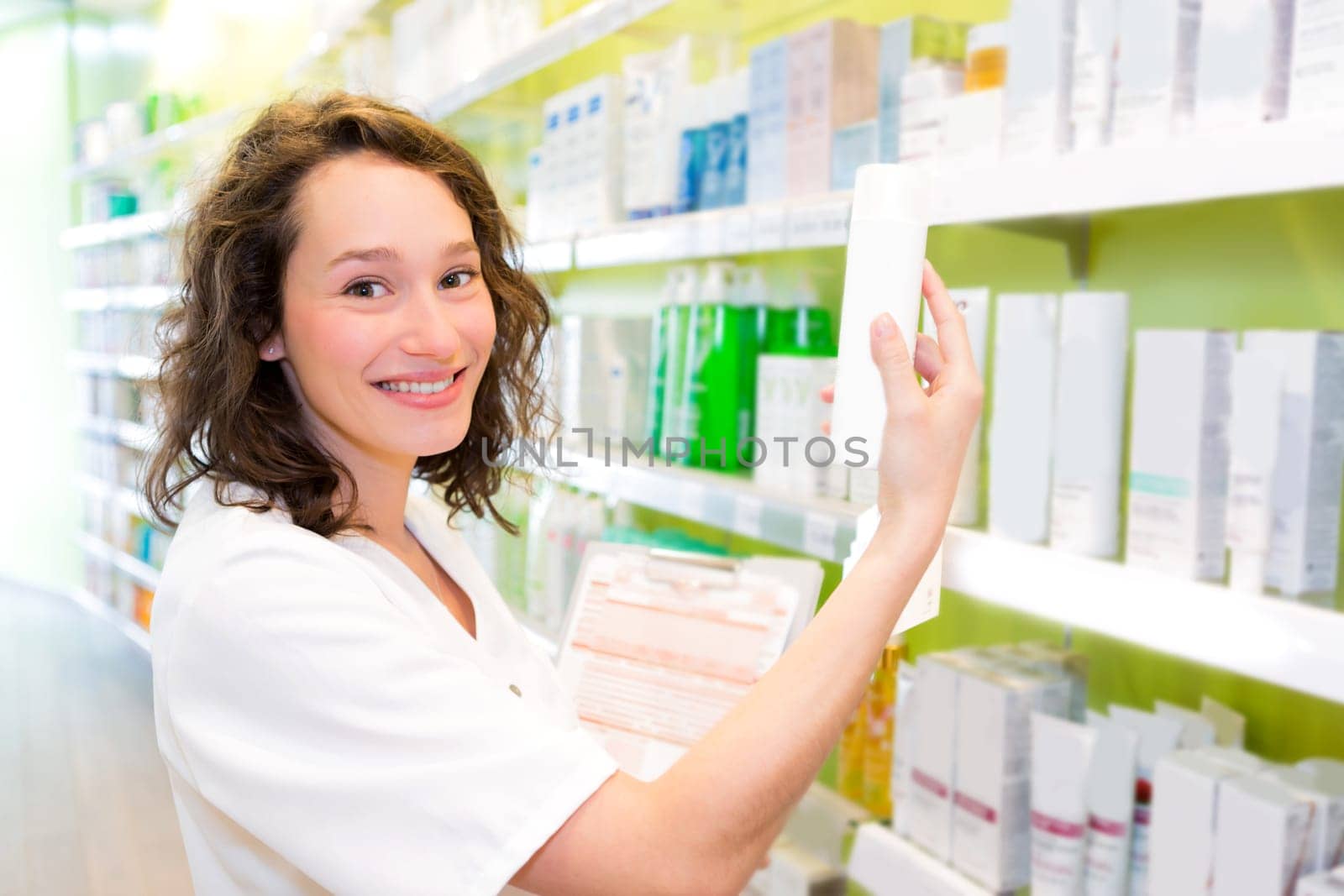 VIew of an Attractive pharmacist clean the store up