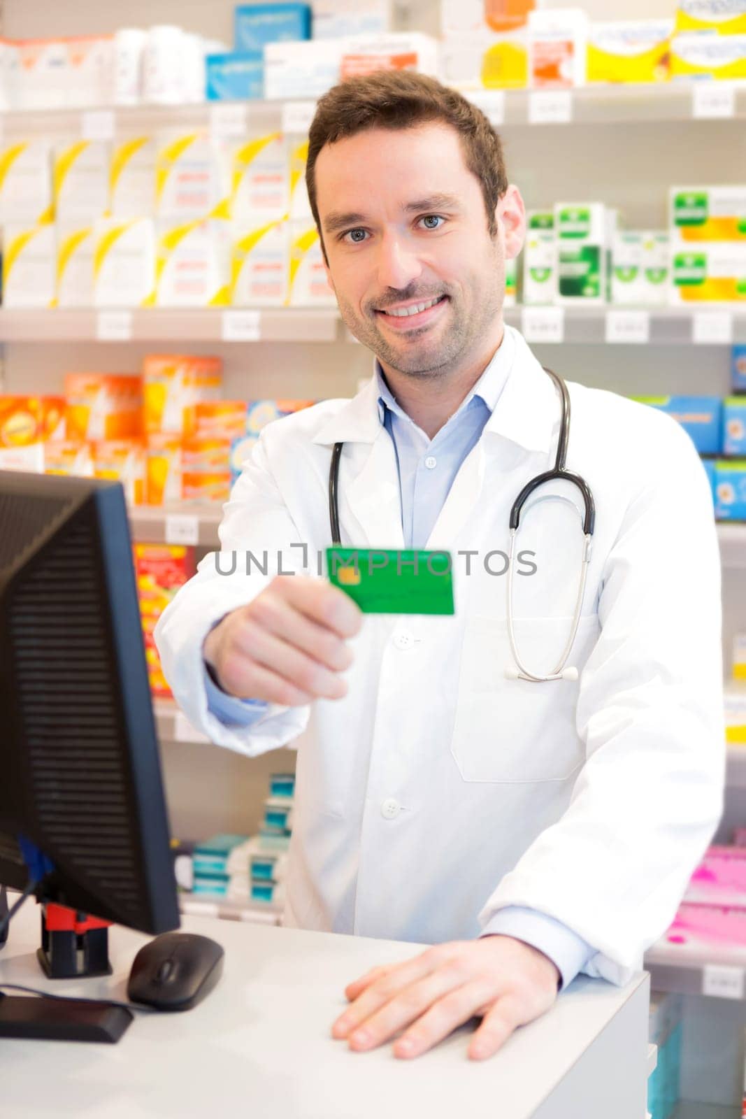 View of an Attractive pharmacist taking healt insurance card