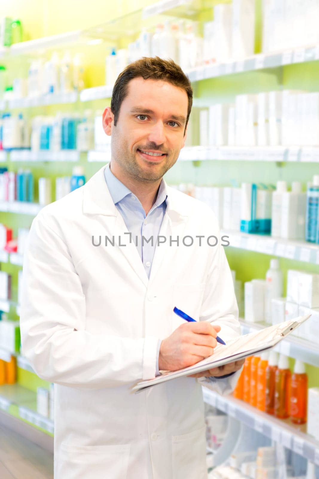 Vjew of a Attractive pharmacist taking notes at work