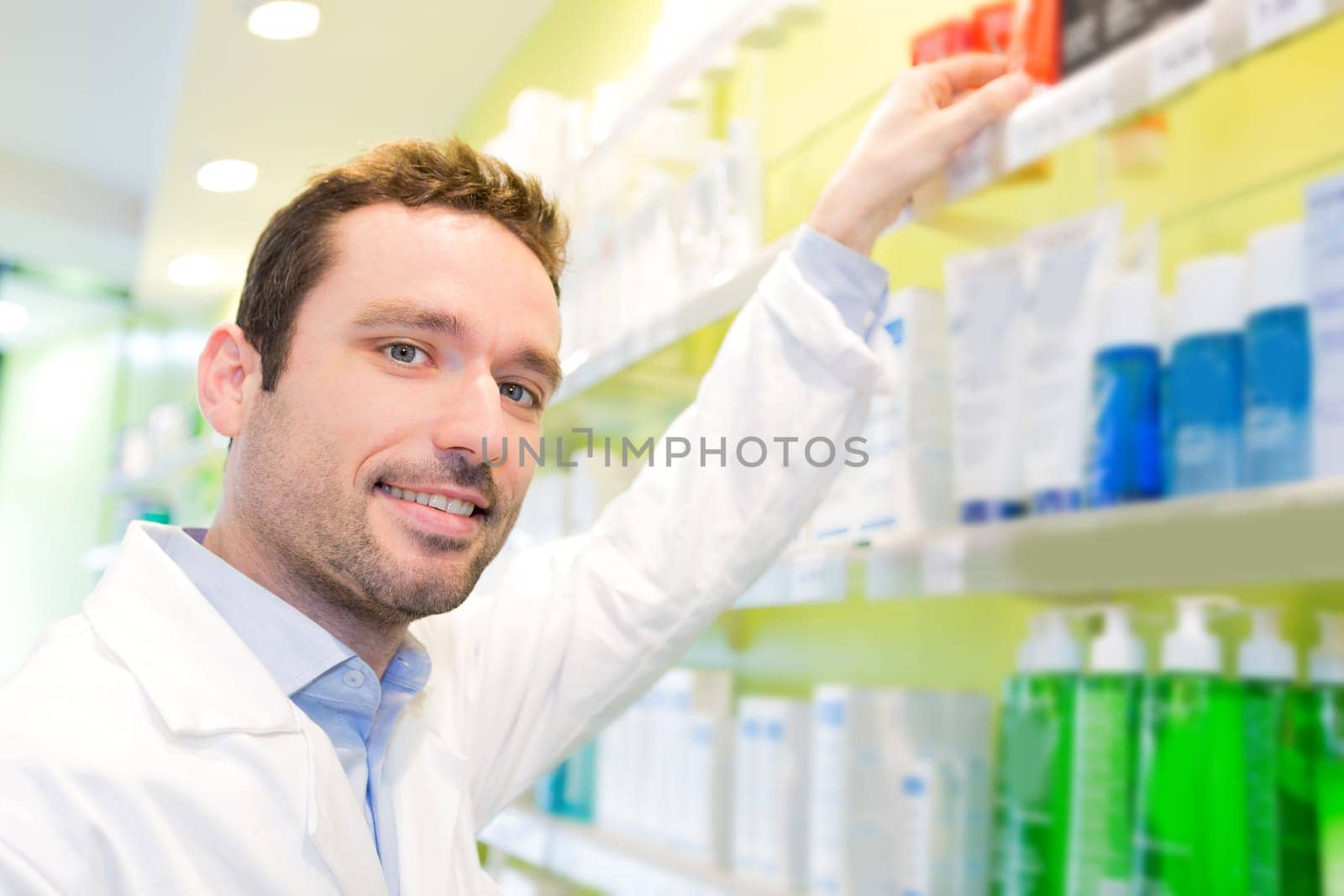 View of an Attractive pharmacist clean the store up