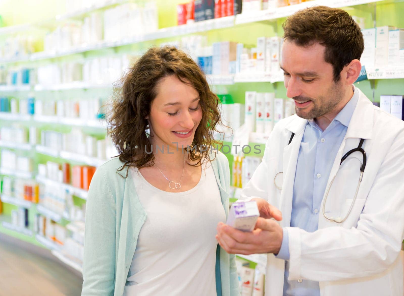 VIew of an Attractive pharmacist advising a patient