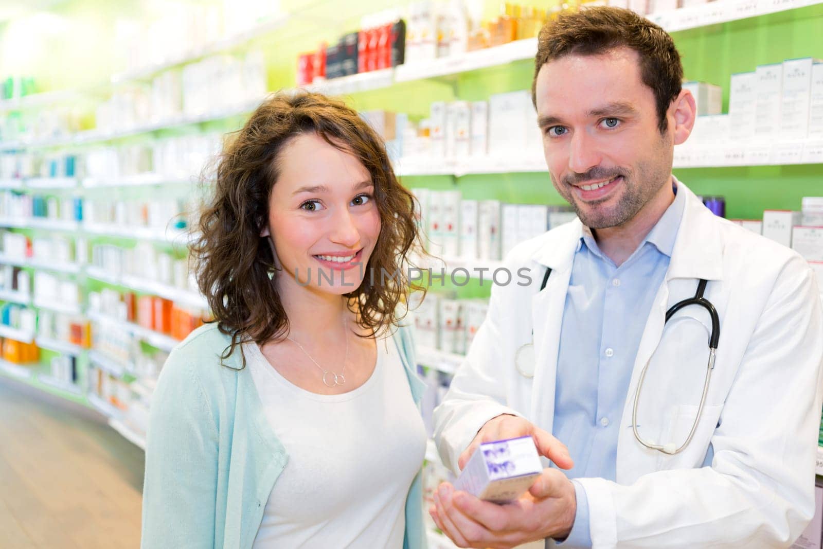 VIew of an Attractive pharmacist advising a patient