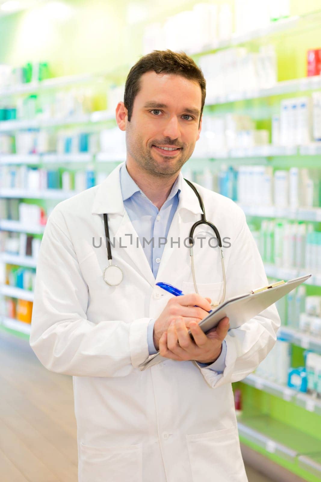 View of a Attractive pharmacist taking notes at work