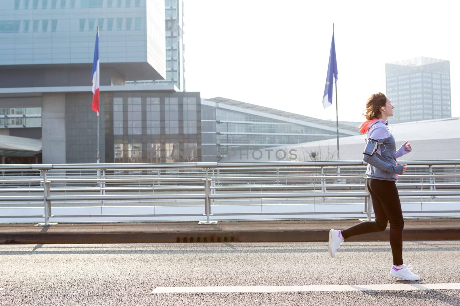 View of a Young attractive woman running downtown