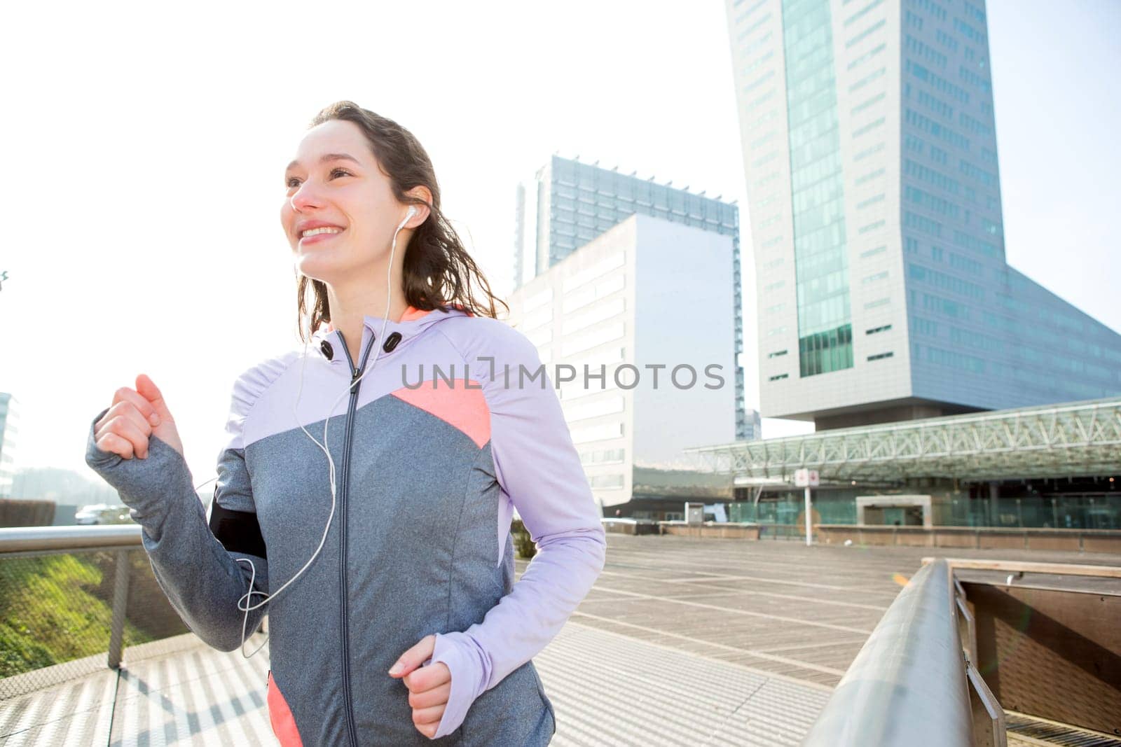 View of a Young attractive woman running downtown
