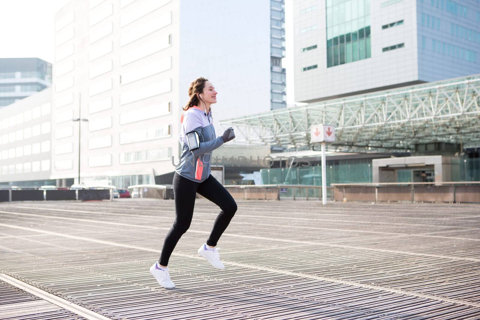View of a Young attractive woman running downtown