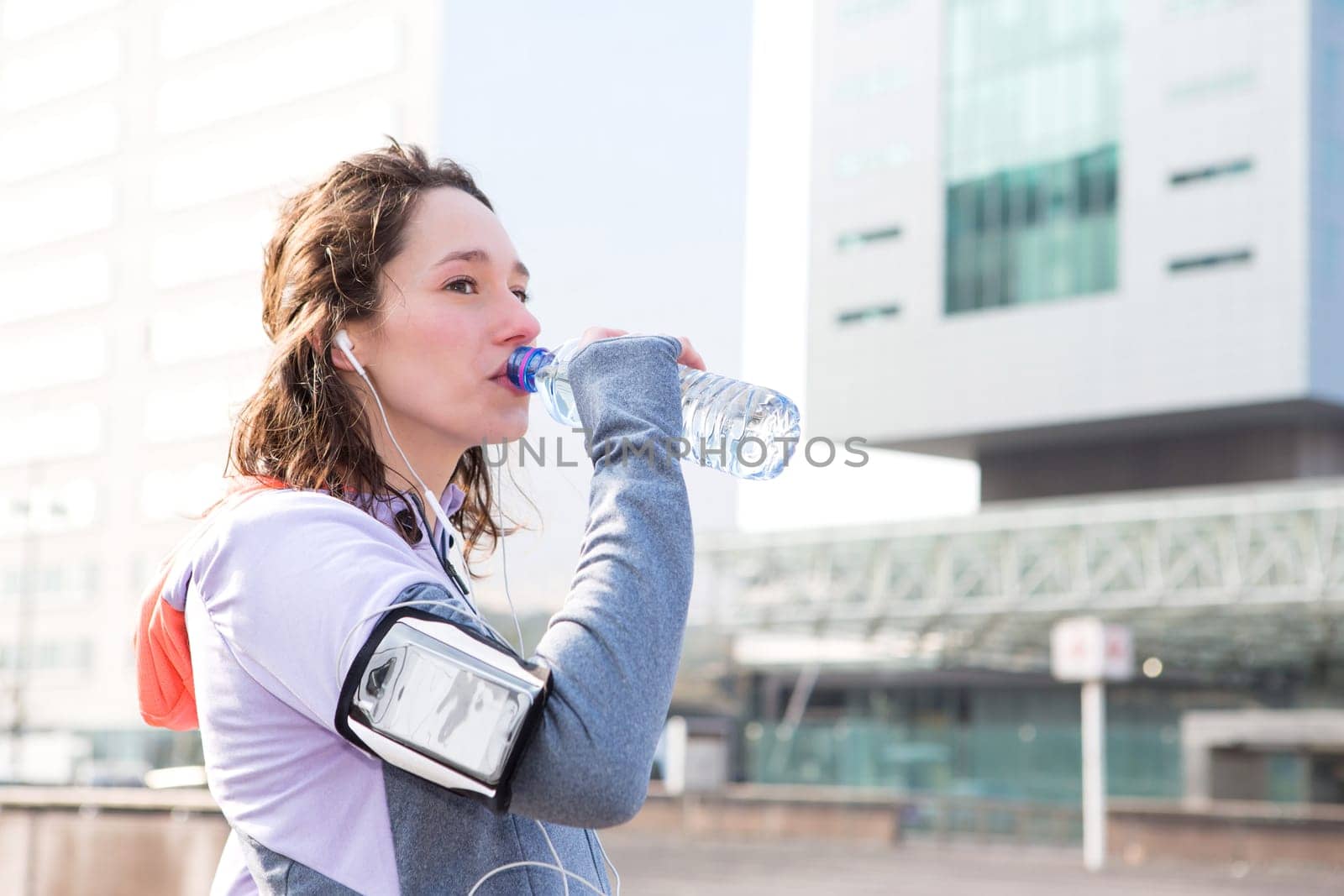 View of a Woman drinking water during a running session