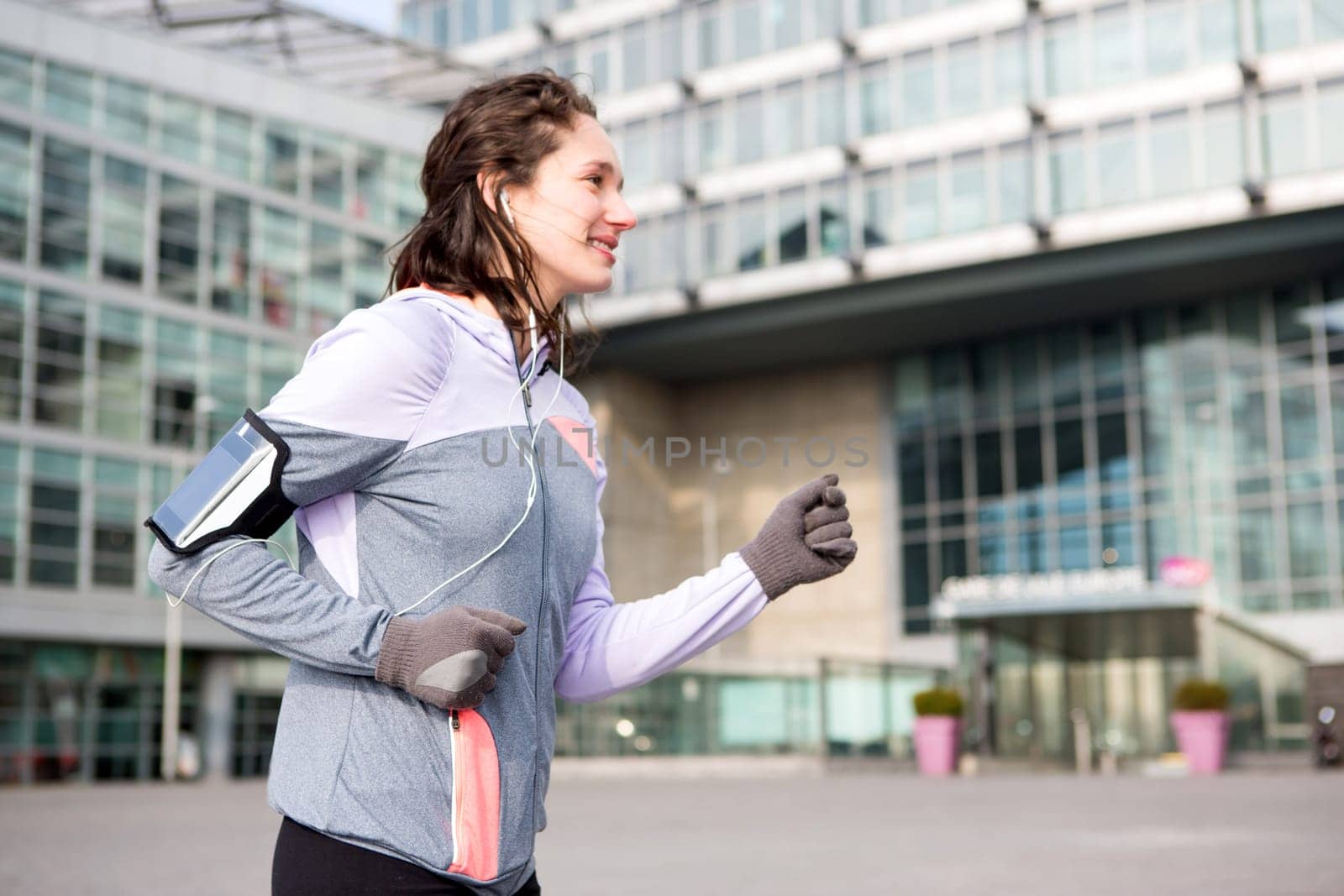 View of a Young attractive woman running downtown