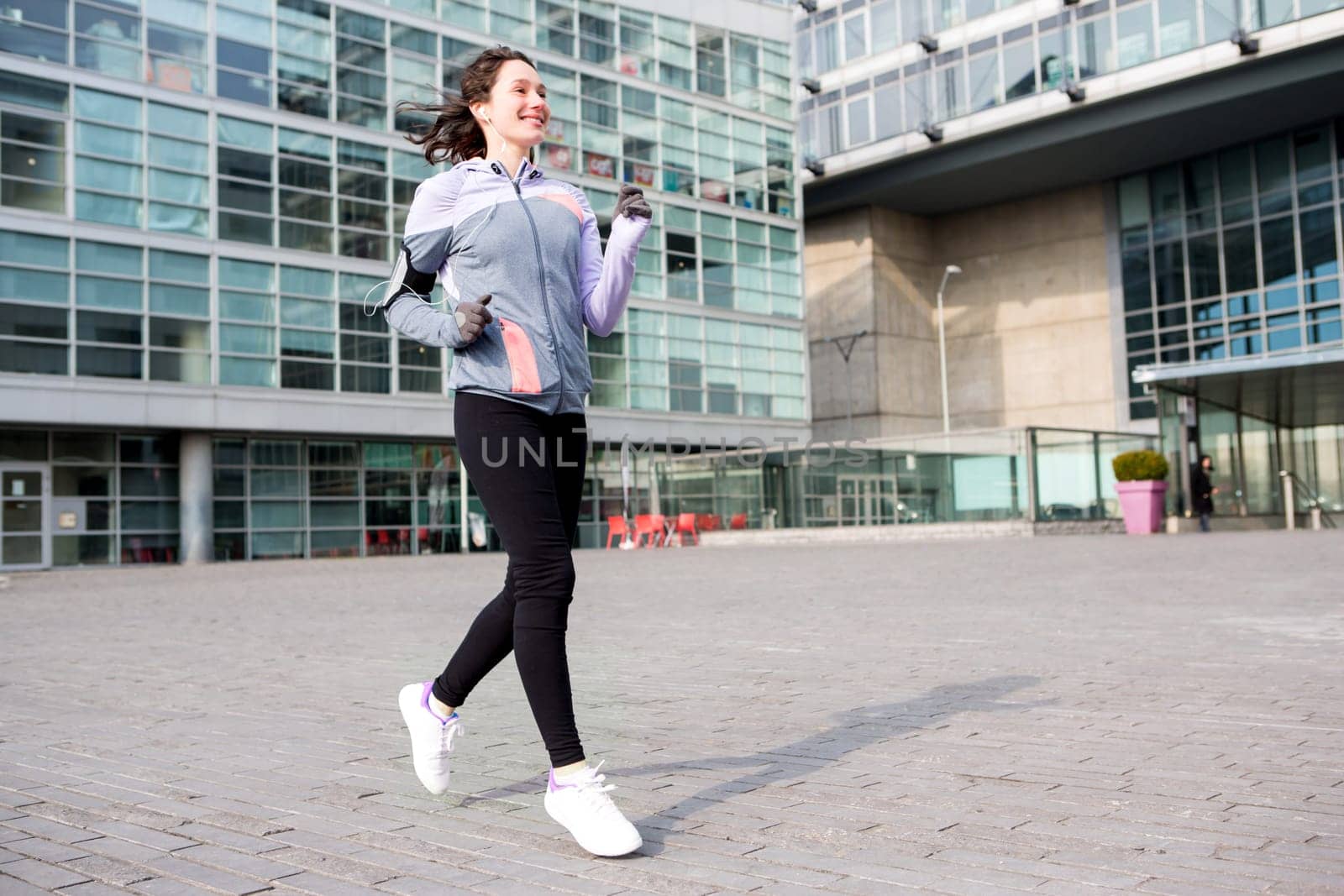 View of a Young attractive woman running downtown