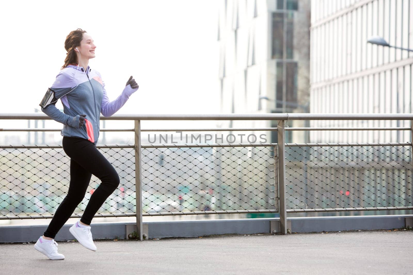 View of a Young attractive woman running downtown