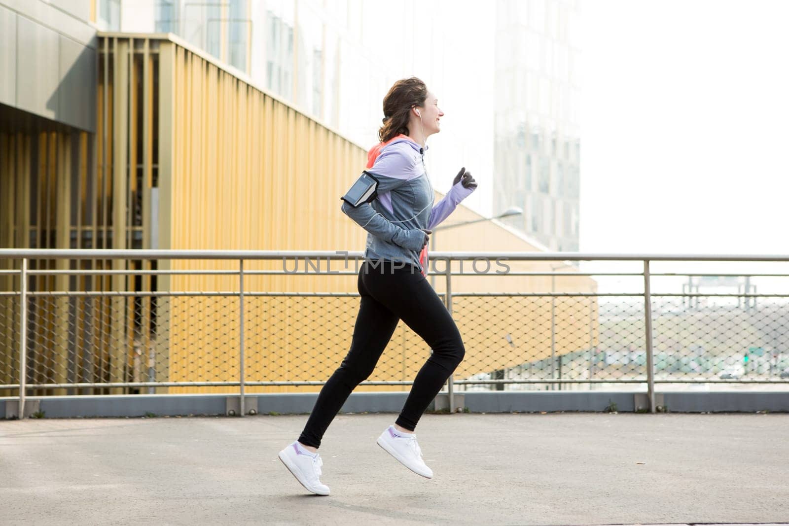 View of a Young attractive woman running downtown