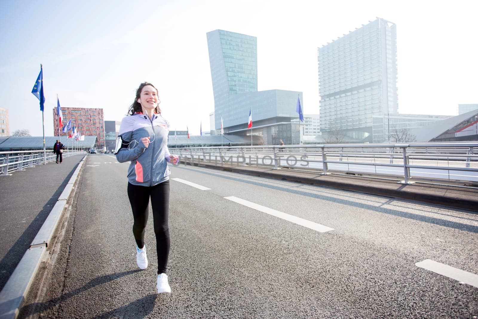 View of a Young attractive woman running downtown