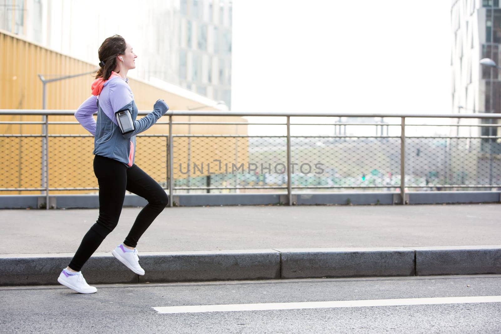 View of a Young attractive woman running downtown