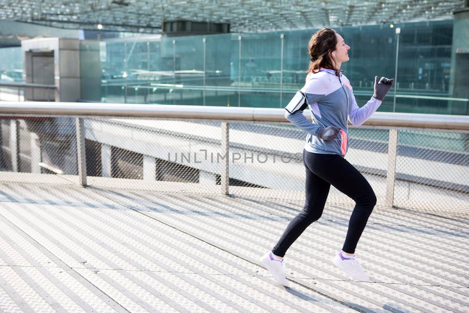 View of a Young attractive woman running downtown