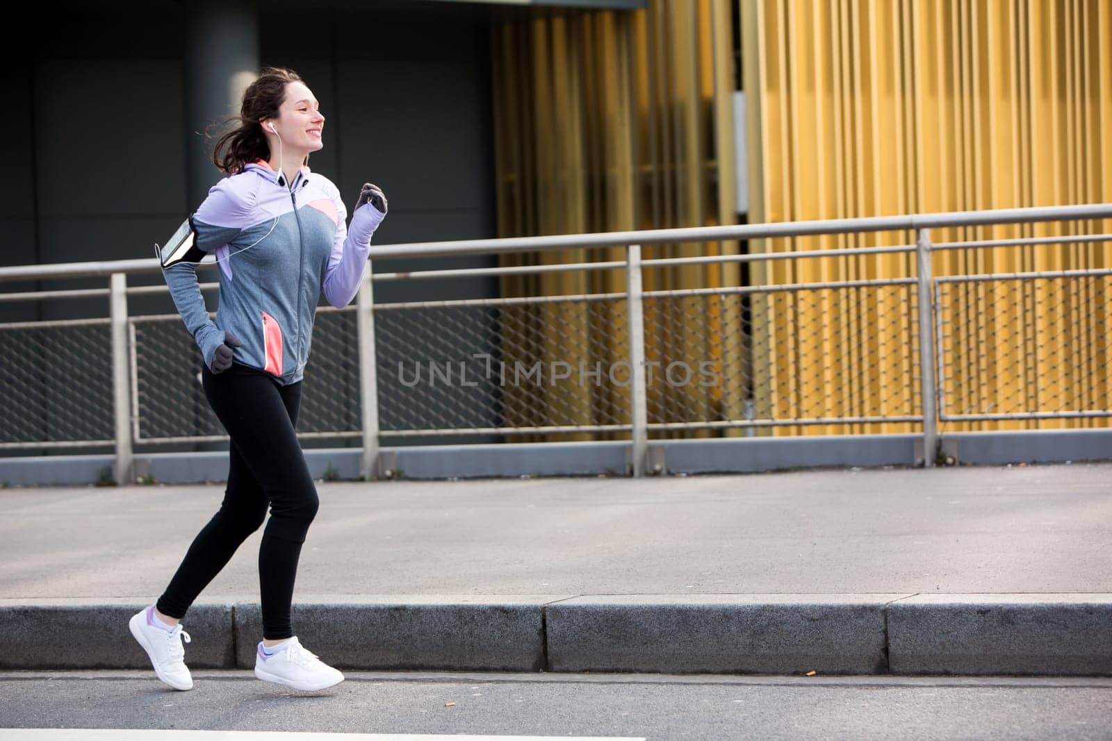 View of a Young attractive woman running downtown