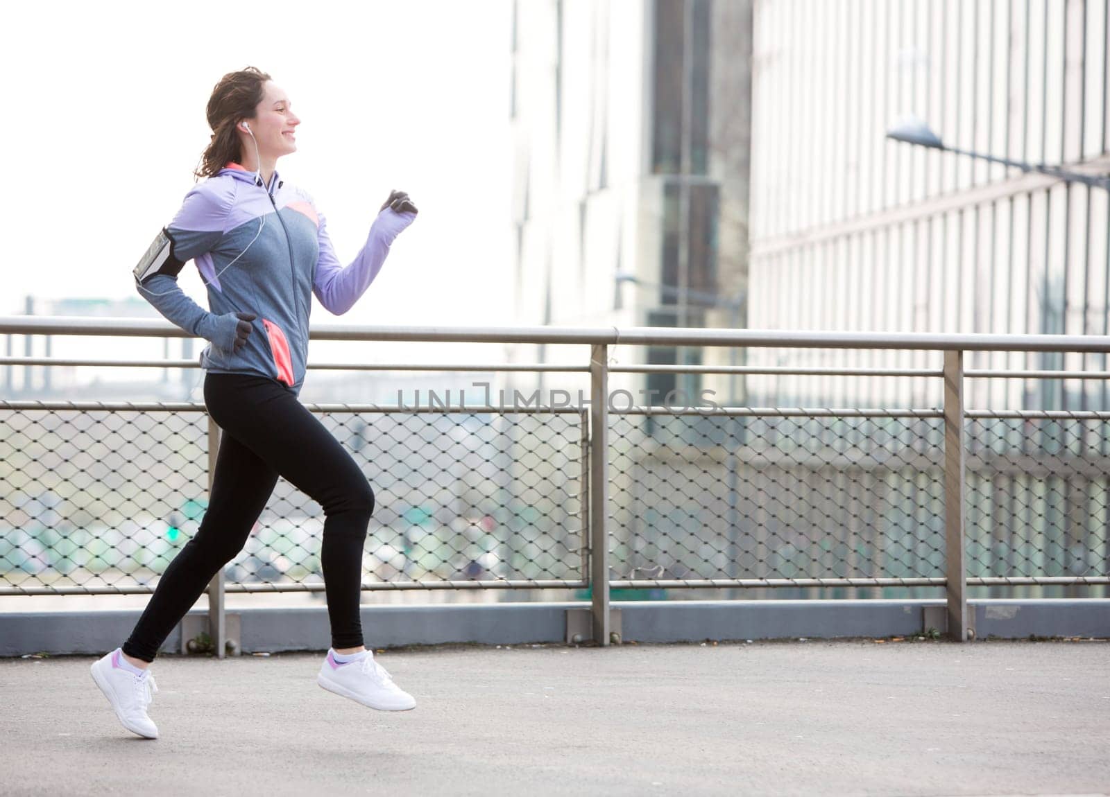View of a Young attractive woman running downtown