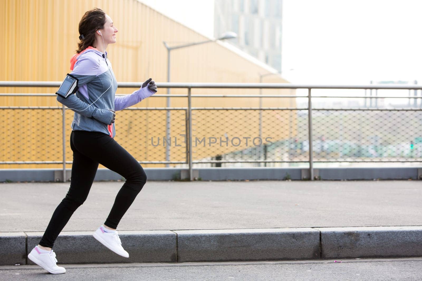 View of a Young attractive woman running downtown