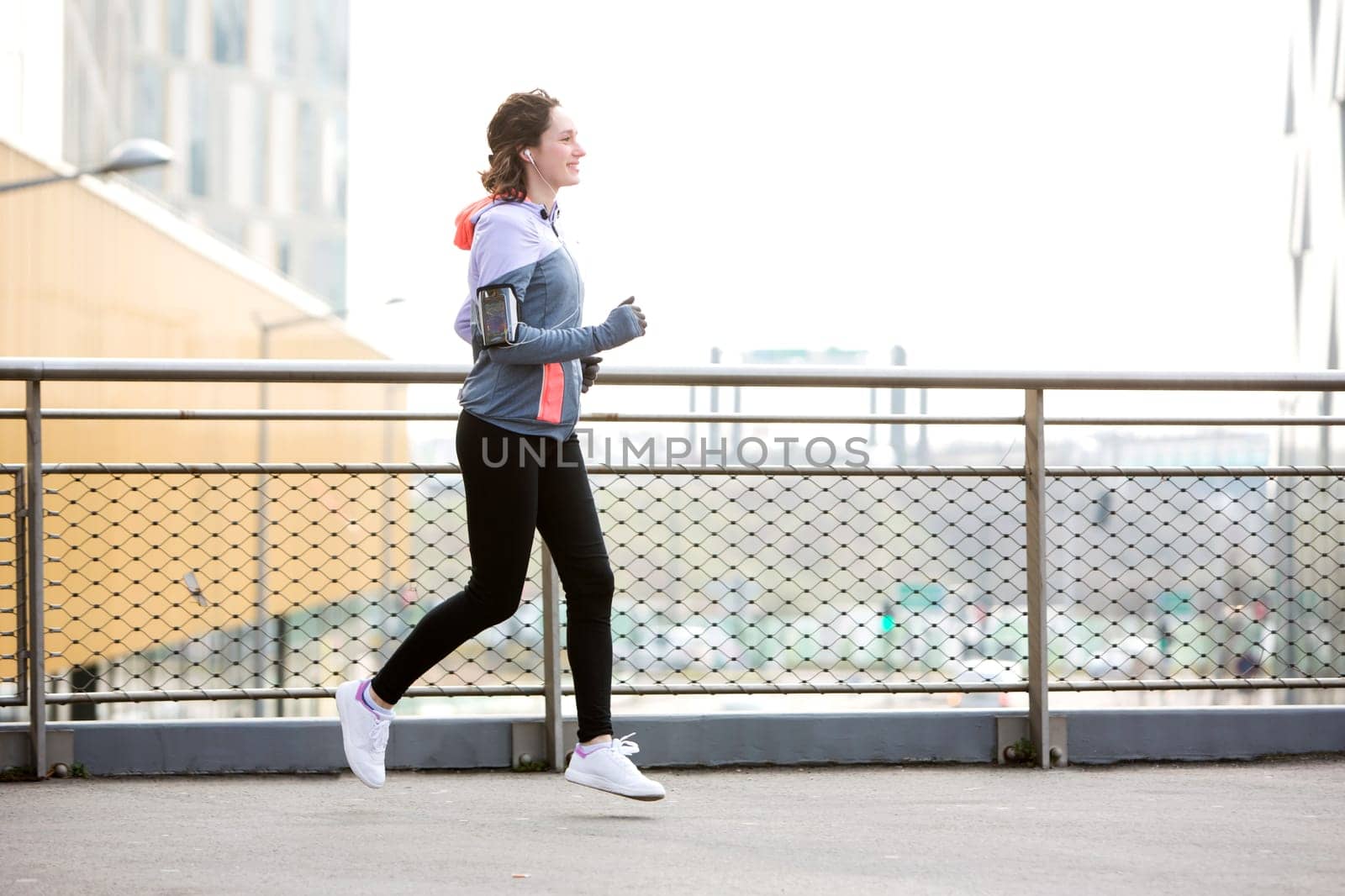 View of a Young attractive woman running downtown