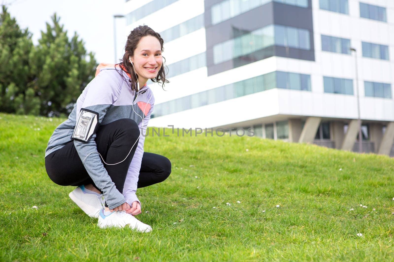 View of a Young attractive woman tying shoelaces before a running session
