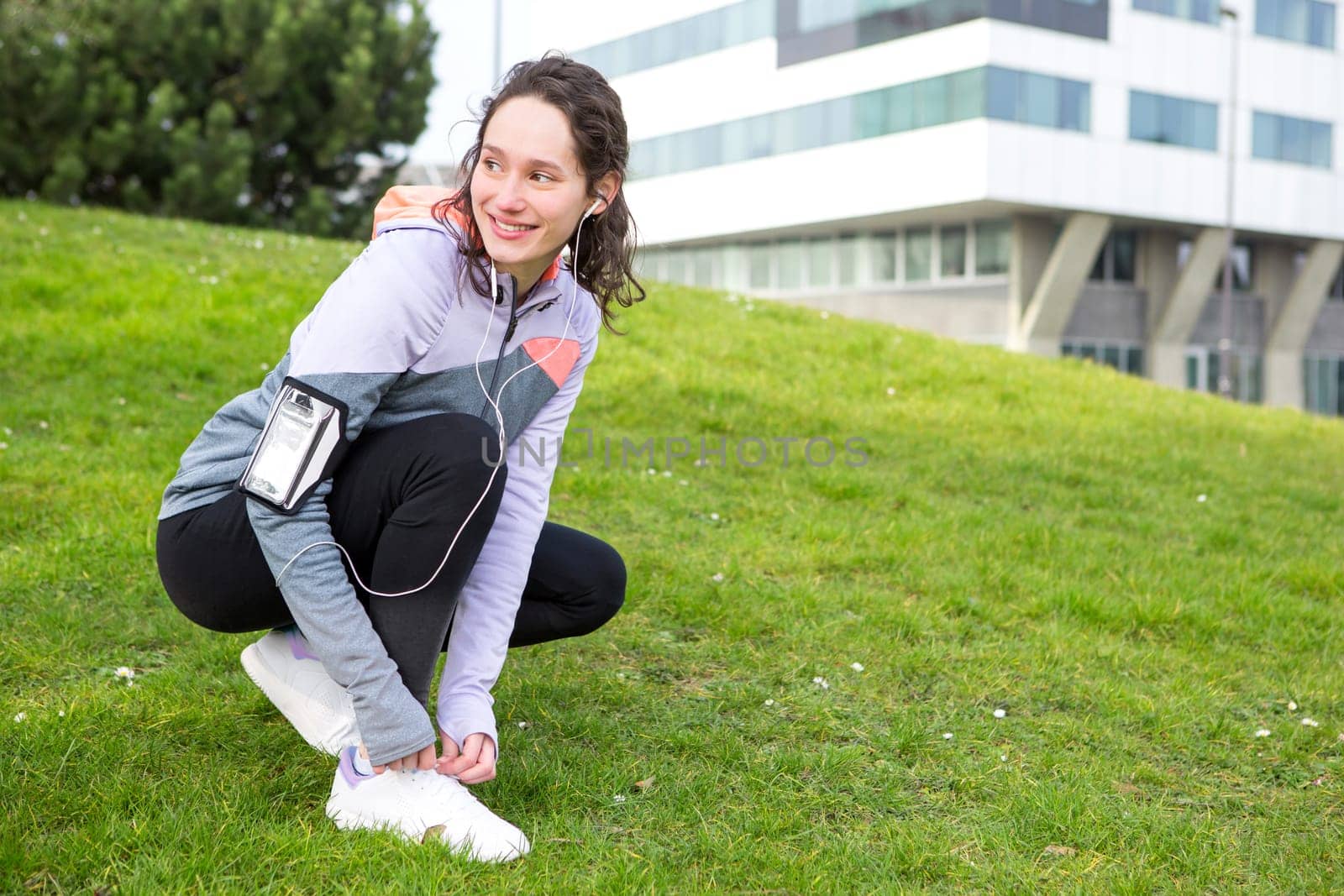 View of a Young attractive woman tying shoelaces before a running session