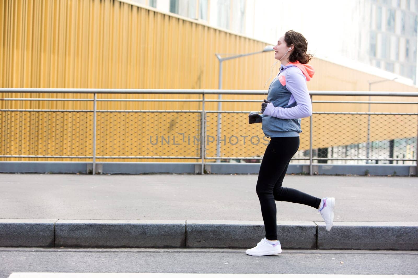 View of a Young attractive woman running downtown