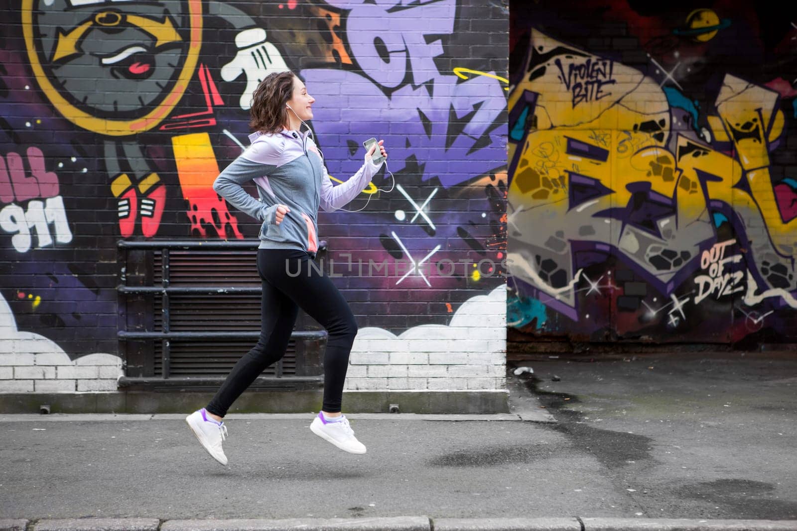 View of a Young attractive woman running downtown