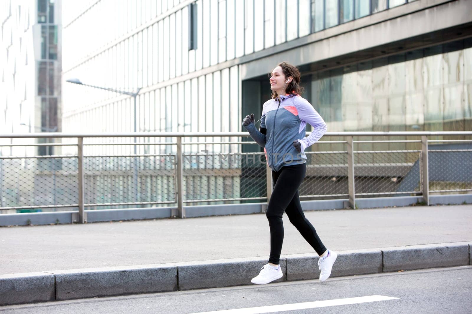 View of a Young attractive woman running downtown