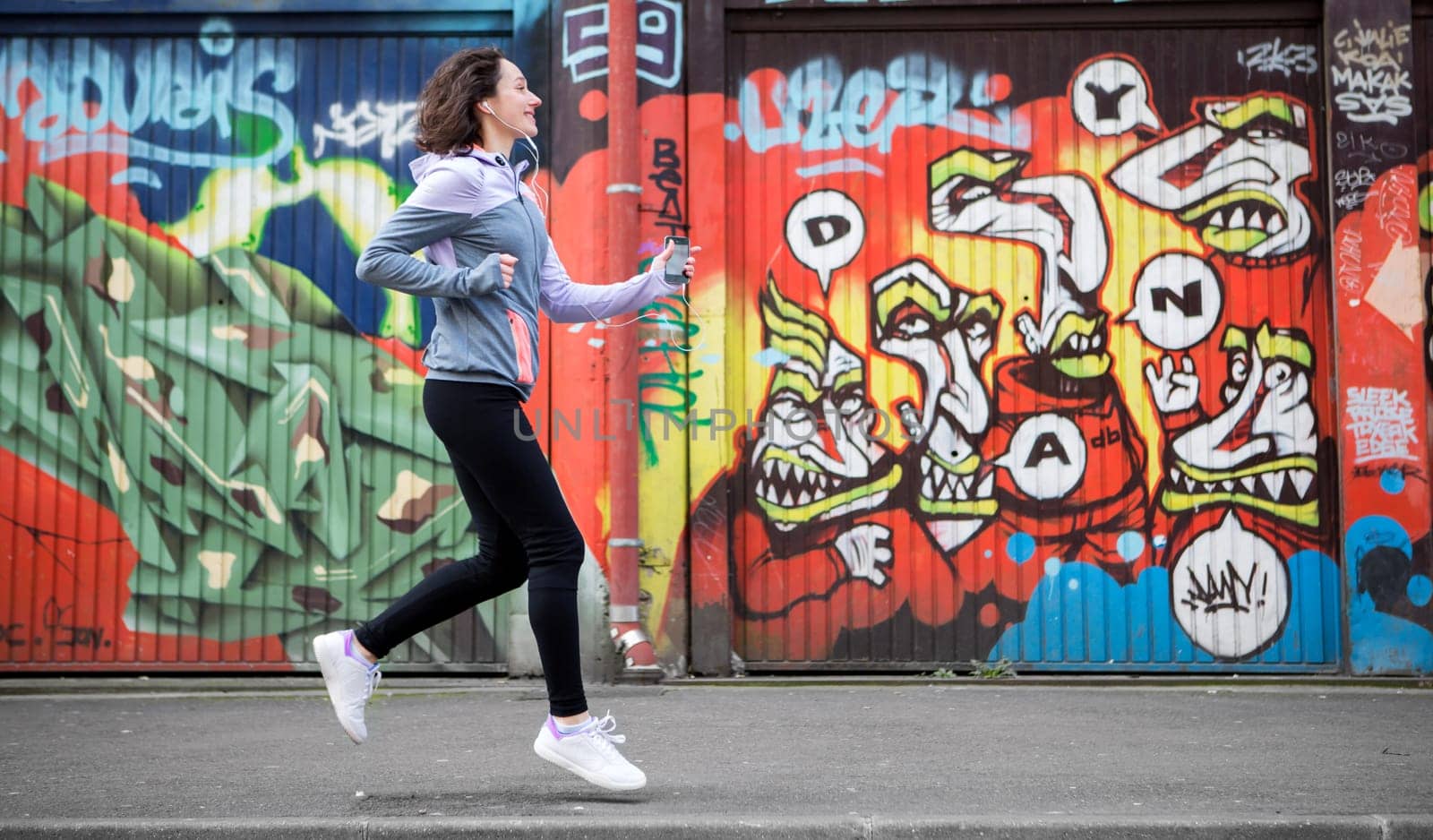 View of a Young attractive woman running downtown