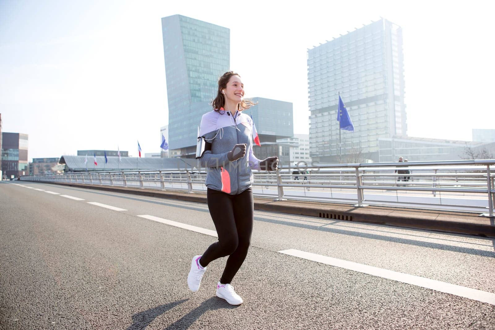 View of a Young attractive woman running downtown