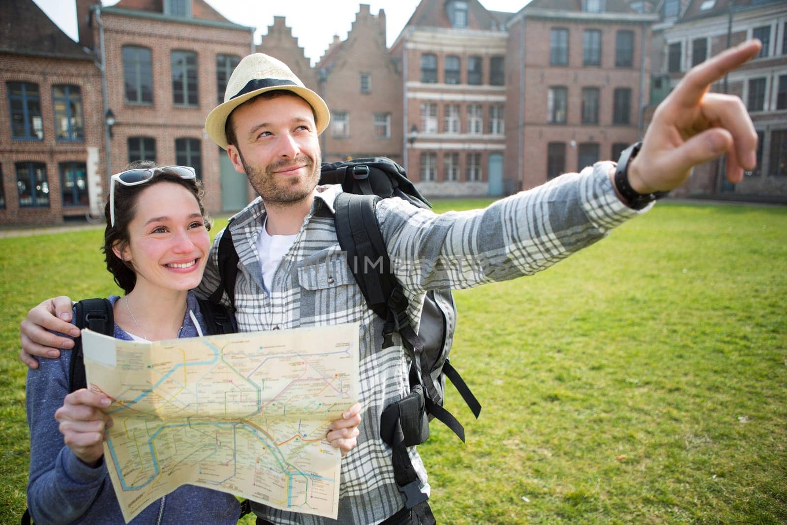 View of a Couple of young attractive tourists watching map