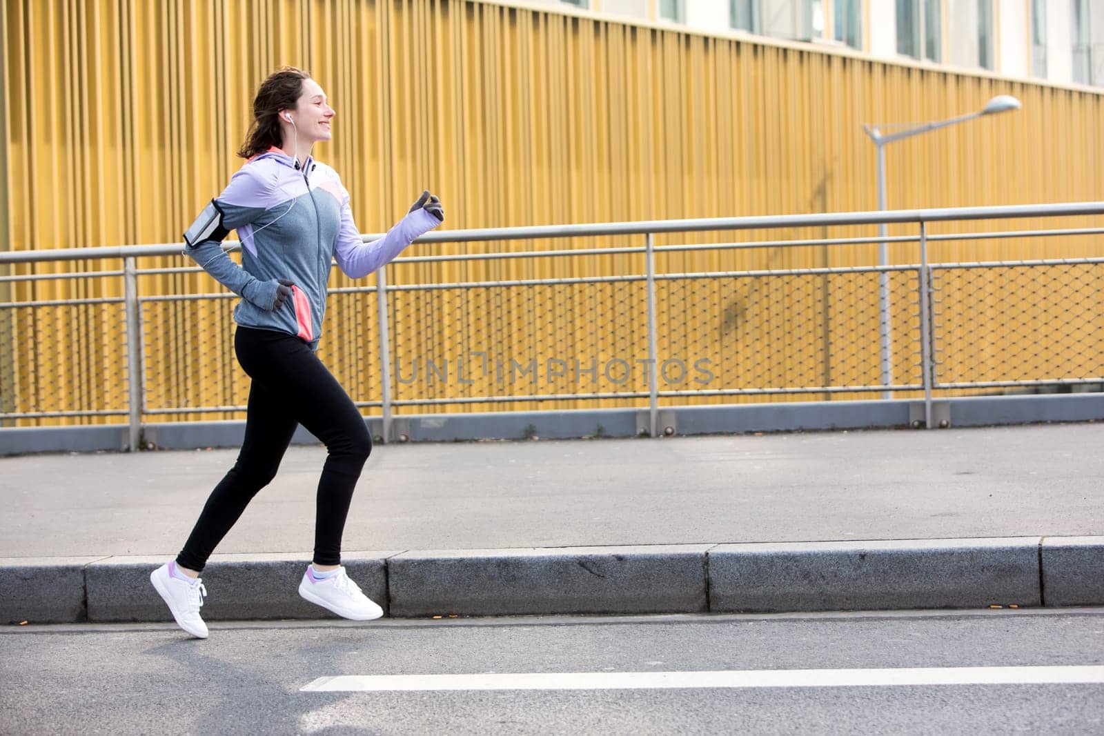 View of a Young attractive woman running downtown