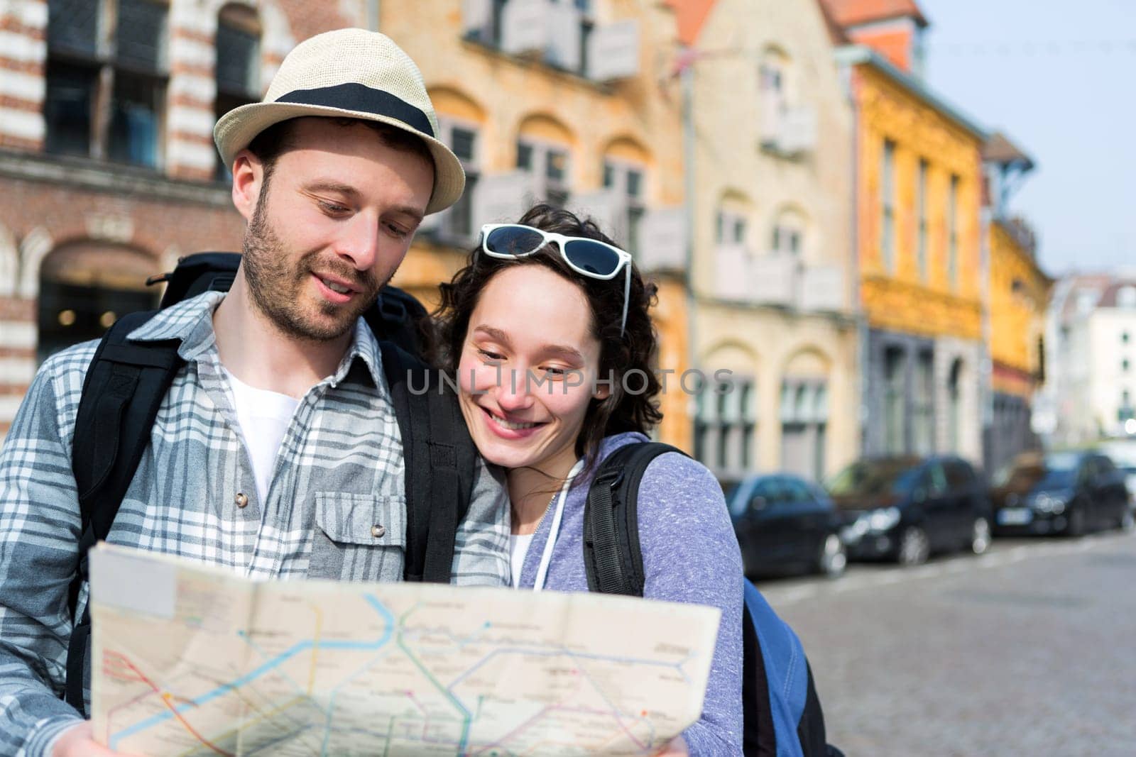 View of a Couple of young attractive tourists watching map