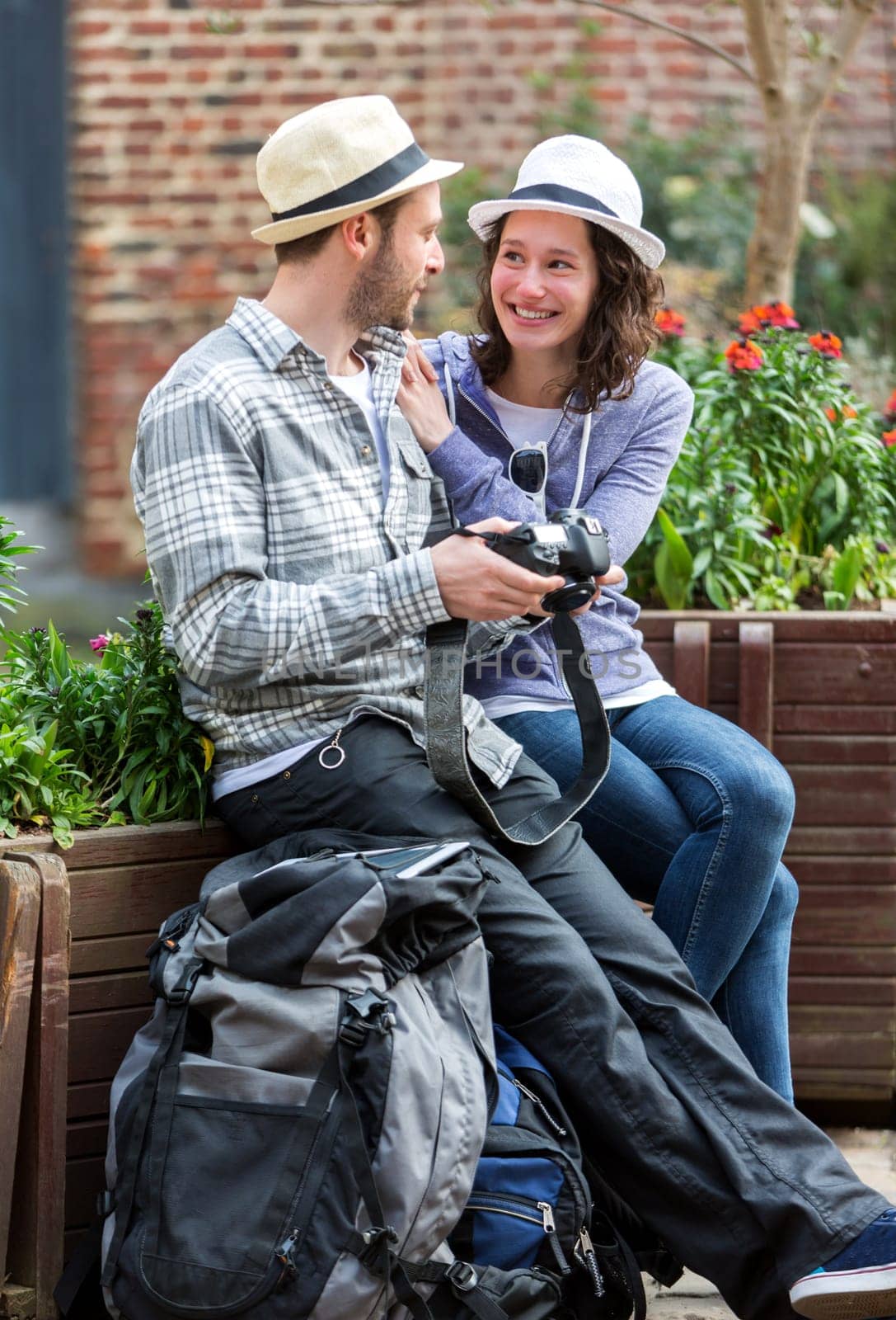 View of a Young couple of tourist watching photographs during a break
