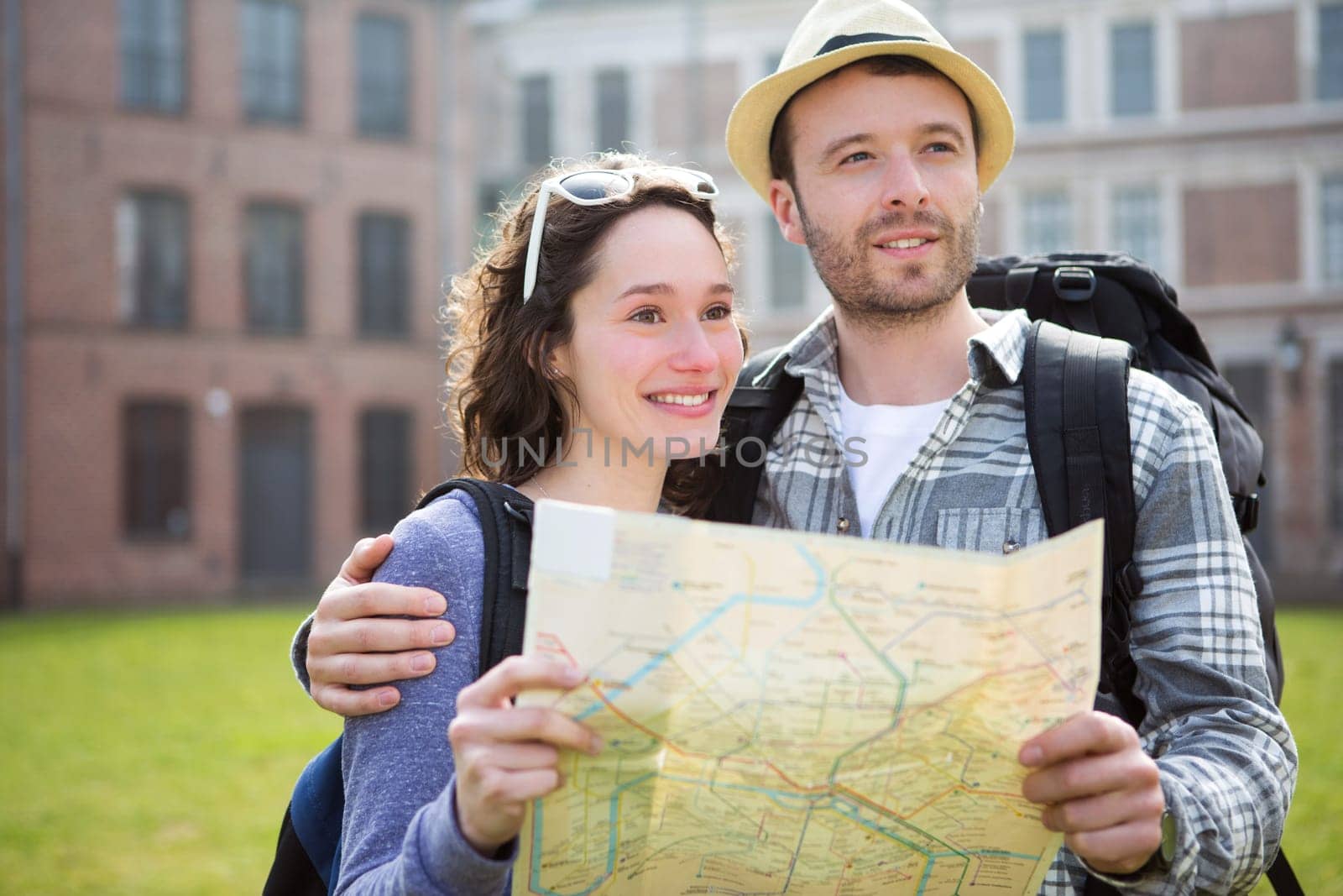 View of a Couple of young attractive tourists watching map