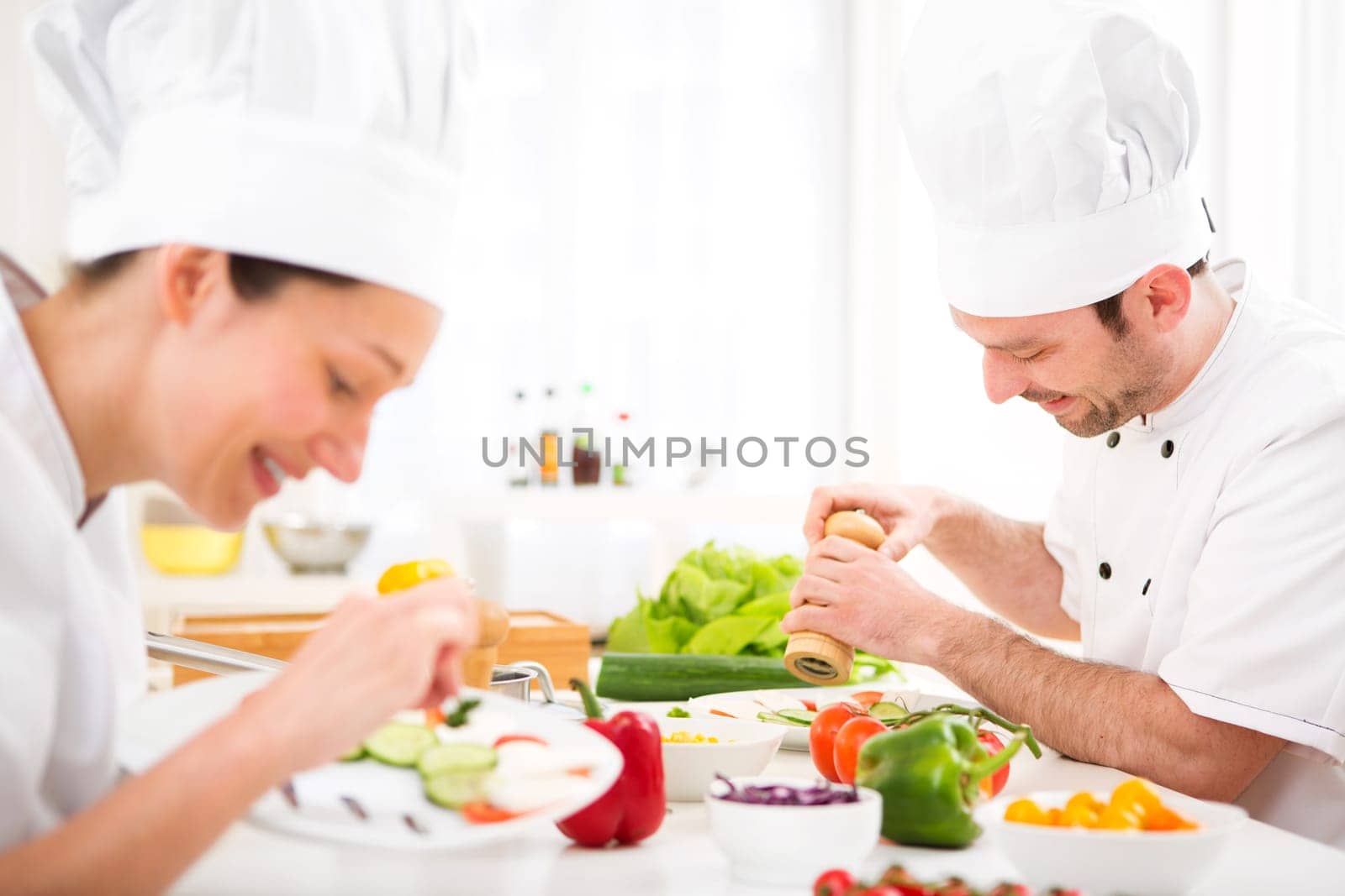 View of a Young attractive professional chef cooking in his kitchen