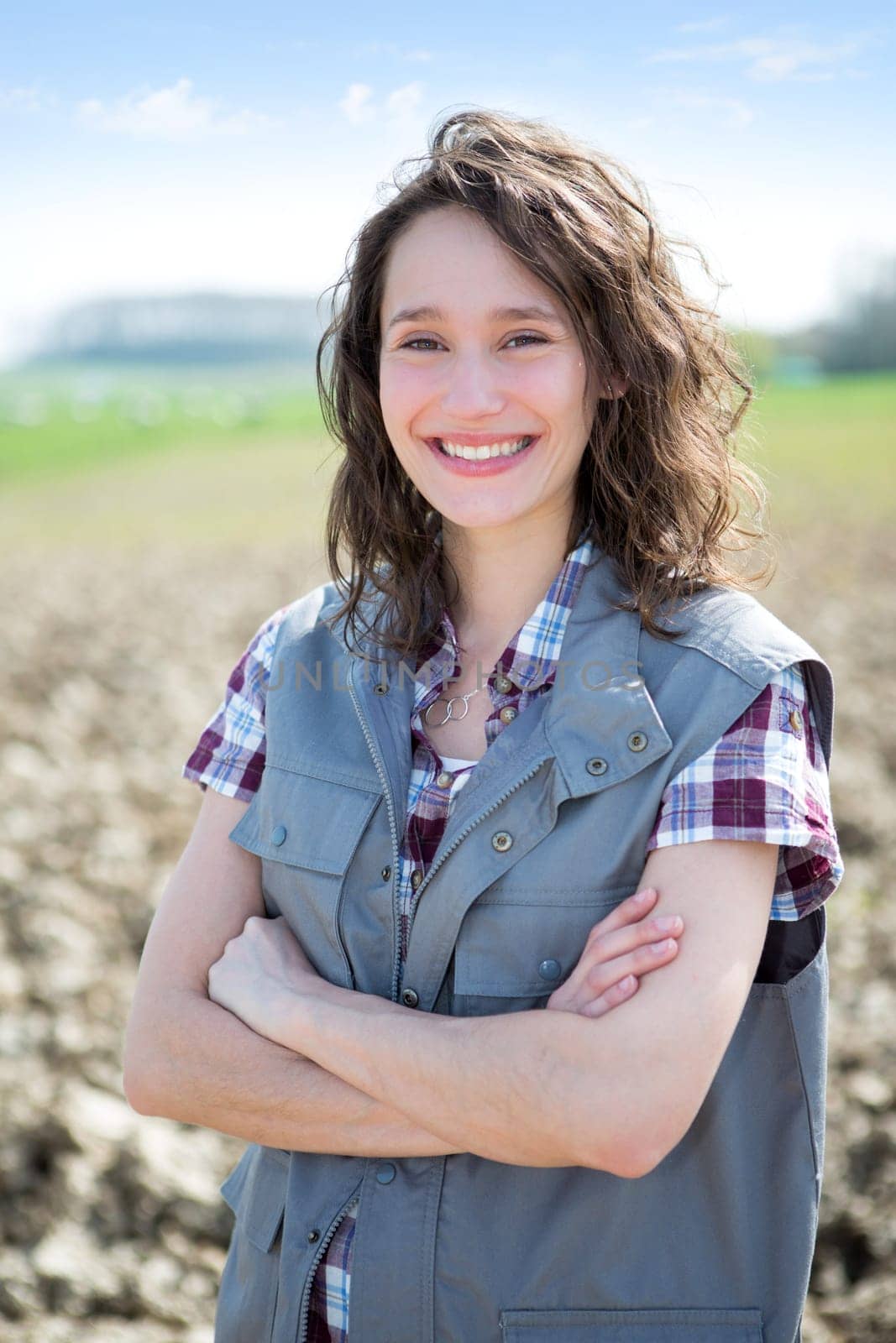 View of a young attractive farmer in fields