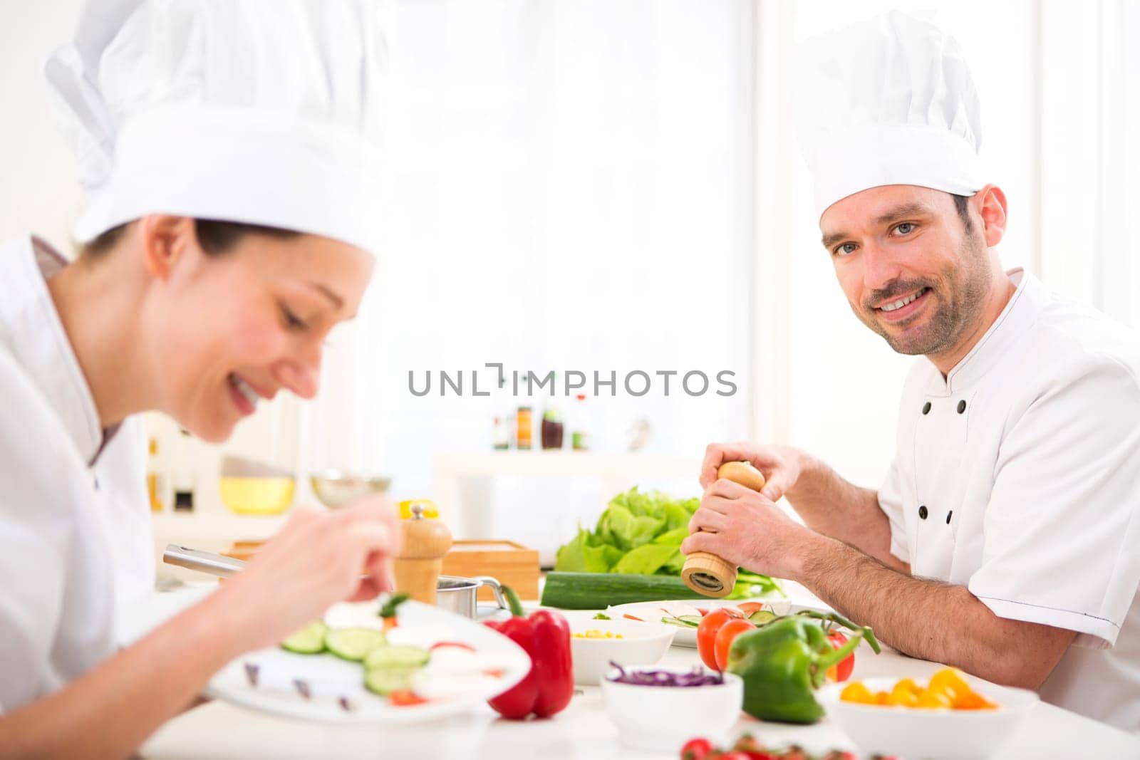 View of a Young attractive professional chef cooking in his kitchen