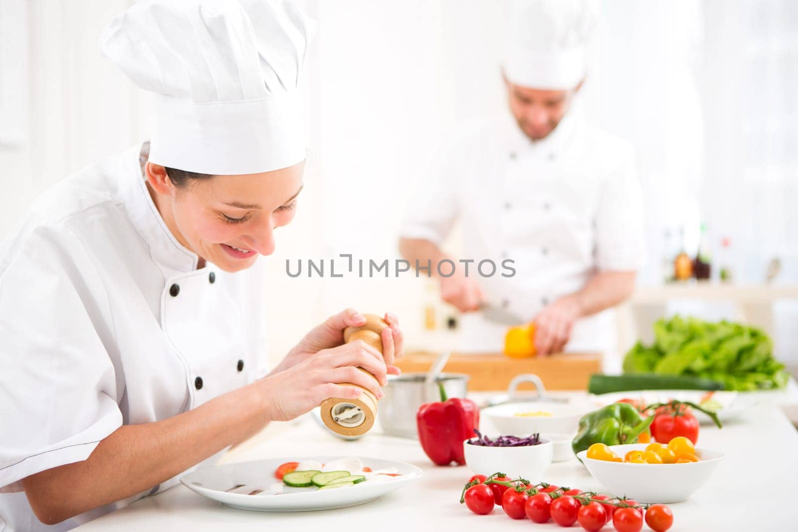 View of a Young attractive professional chef cooking in his kitchen